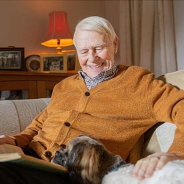 Retired man at home with his dog