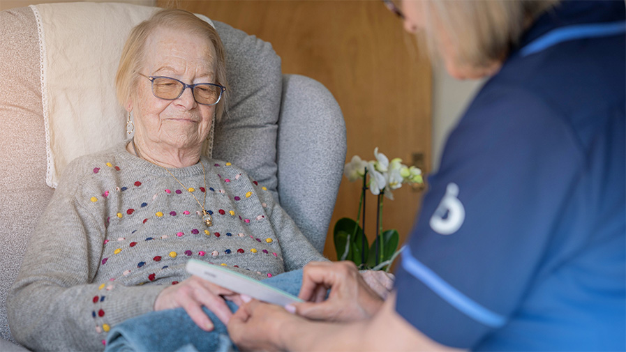Female Bluebird Care customer receiving a nail care treatment at home from a care professional