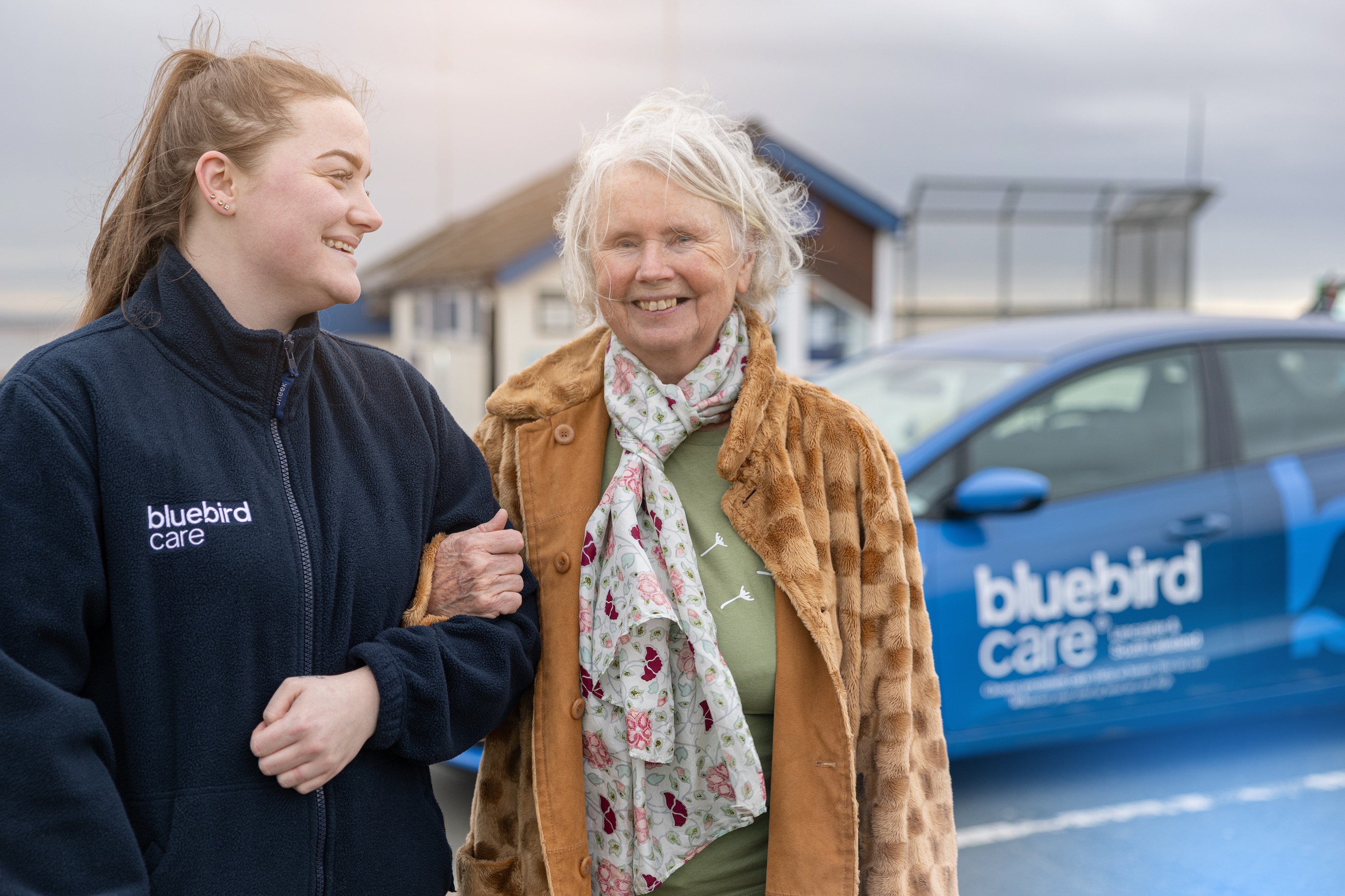 Hands held with client Bluebird car background