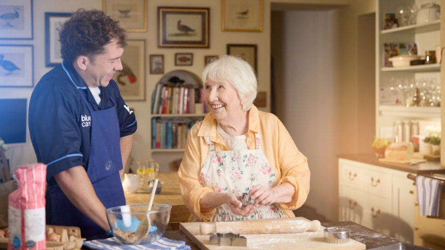 Lady baking with carer