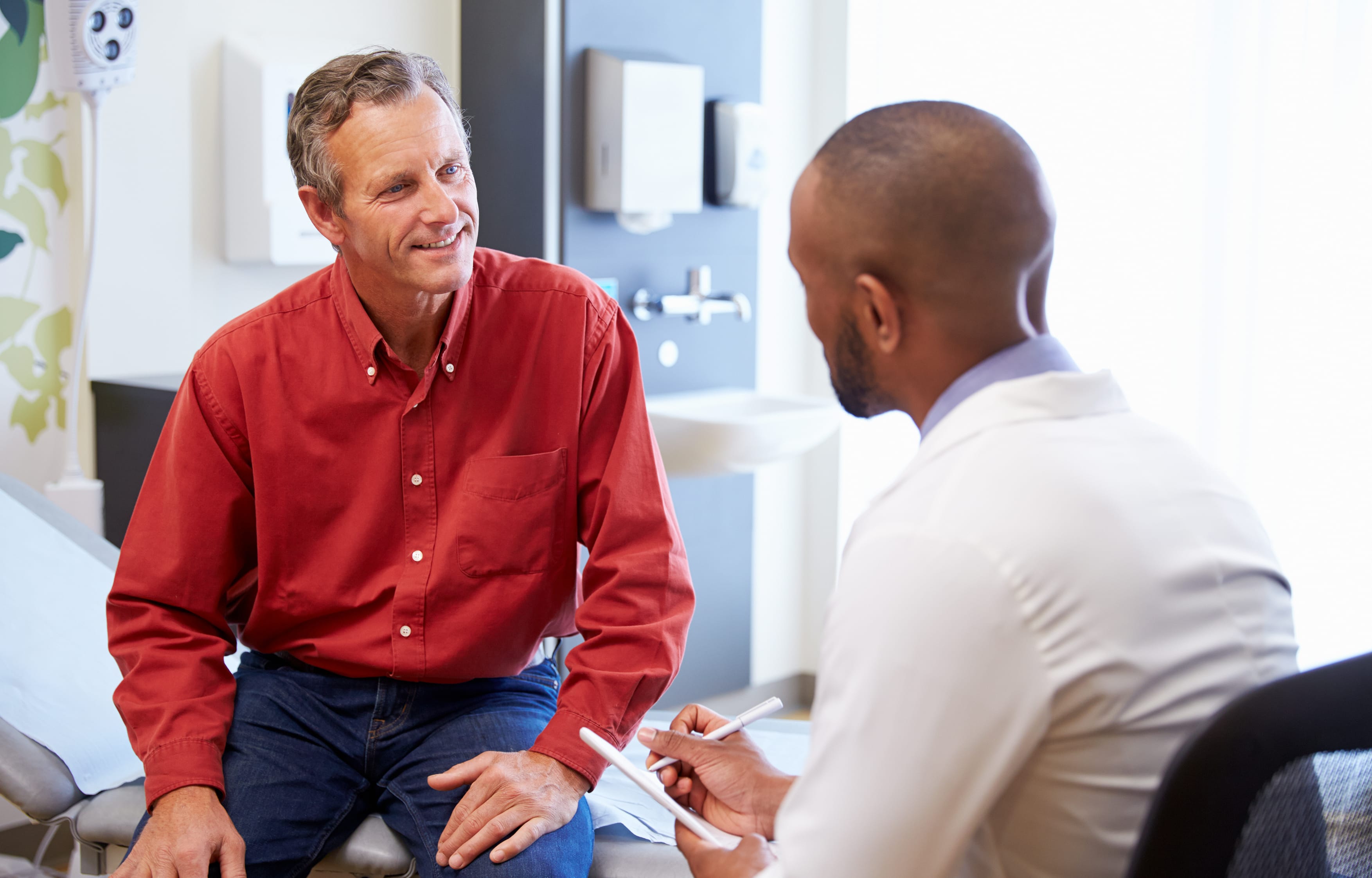 Man sat with doctor for recommended medical test