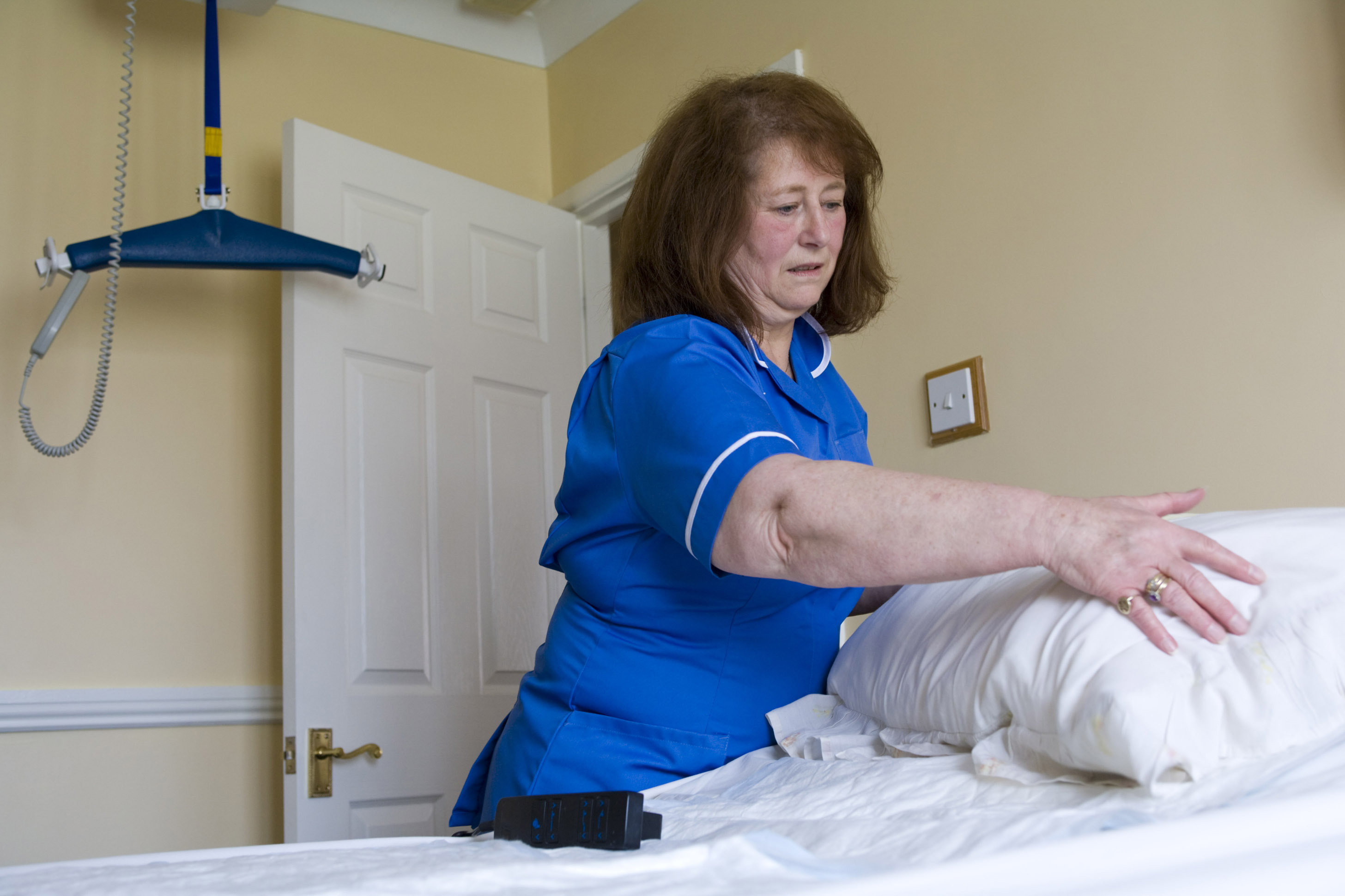 End of life care, carer making a bed