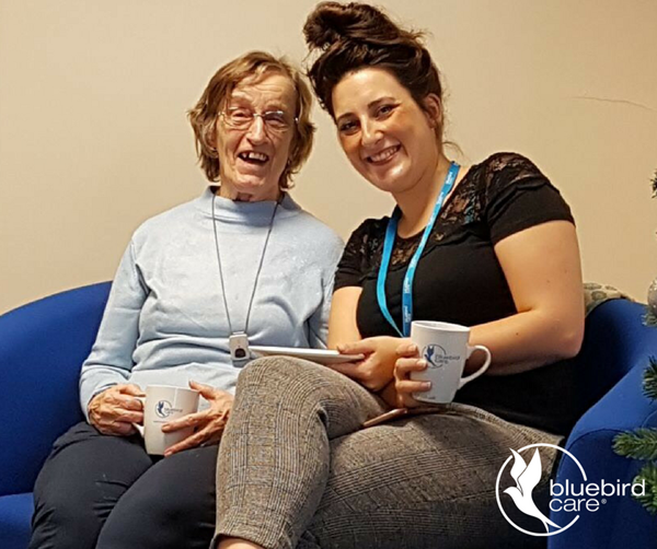 Bluebird Care East Devon Manager drinking tea with a customer