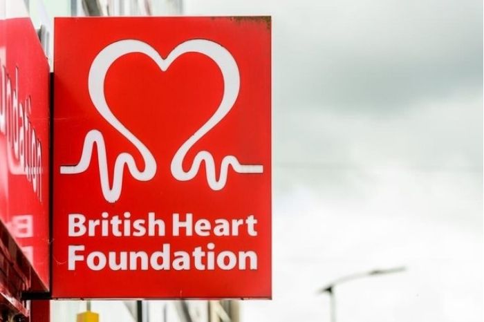 A British Heart Foundation sign hangs outside one of their shops on a high street