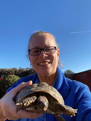 A Bluebird Care Live in care assistant with her pet turtle