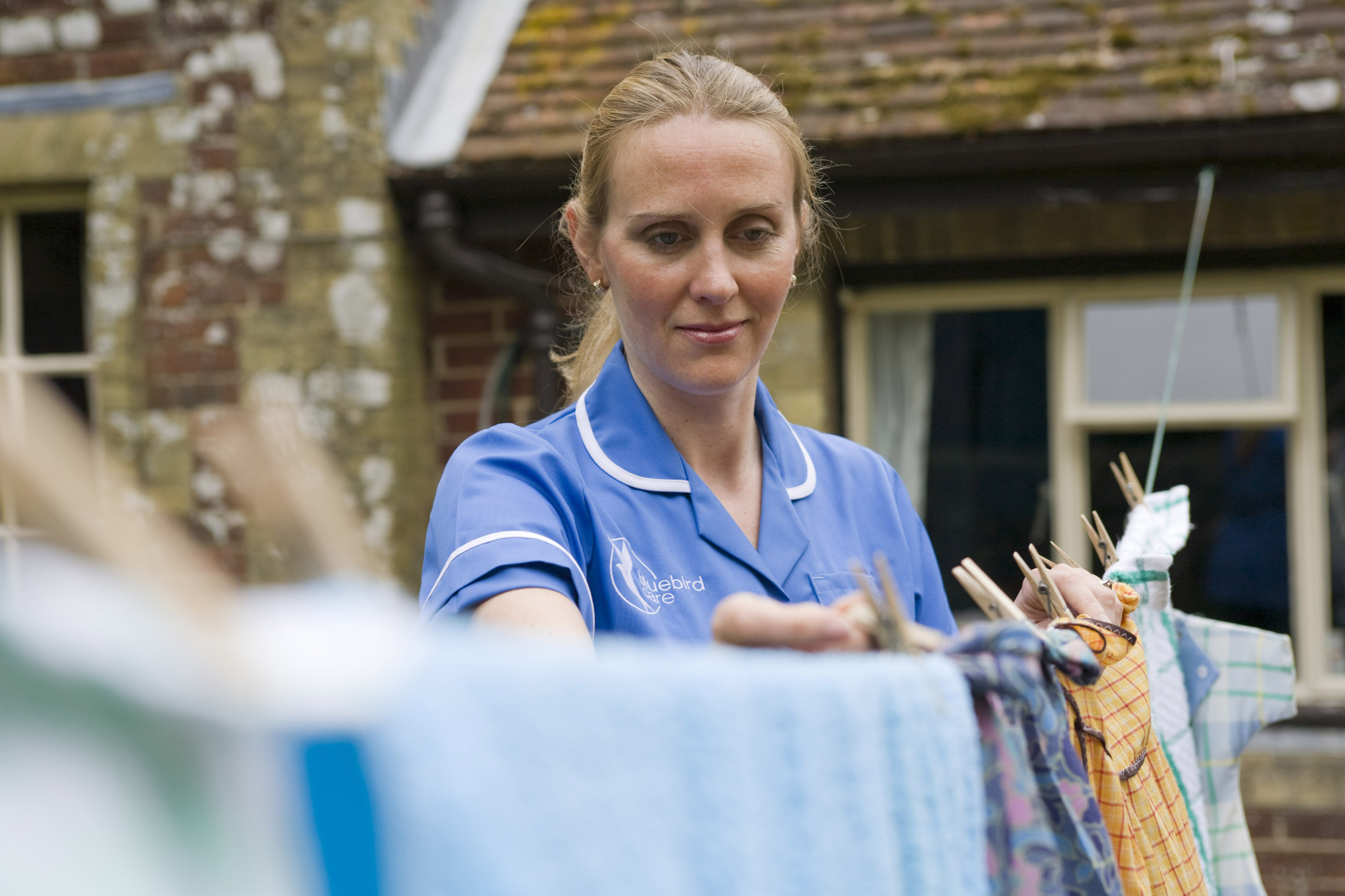 End of life care, carer hanging washing out