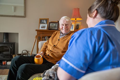 Bluebird care assistant with a happy customer